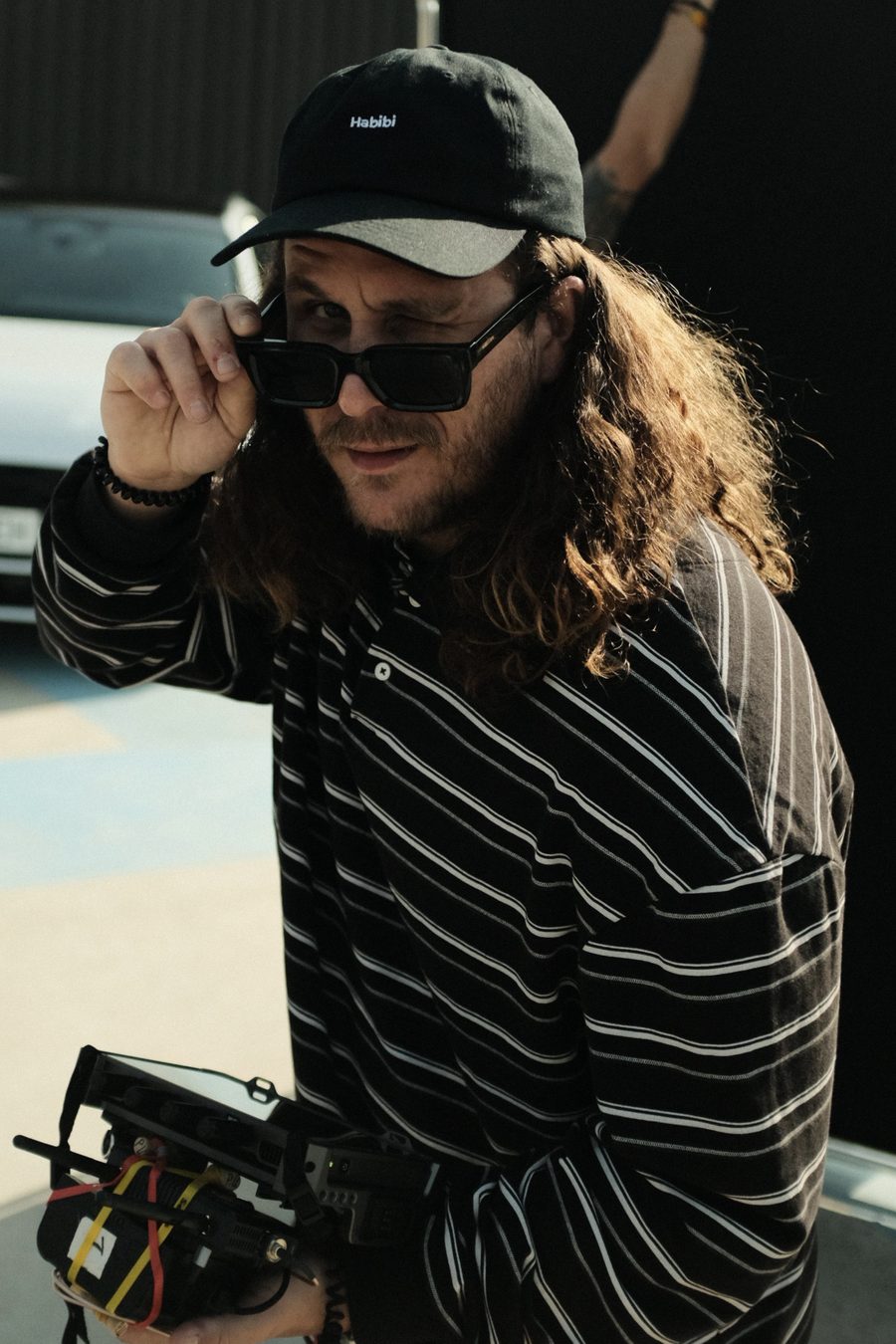 Joaco Phelan on set, holding a monitor